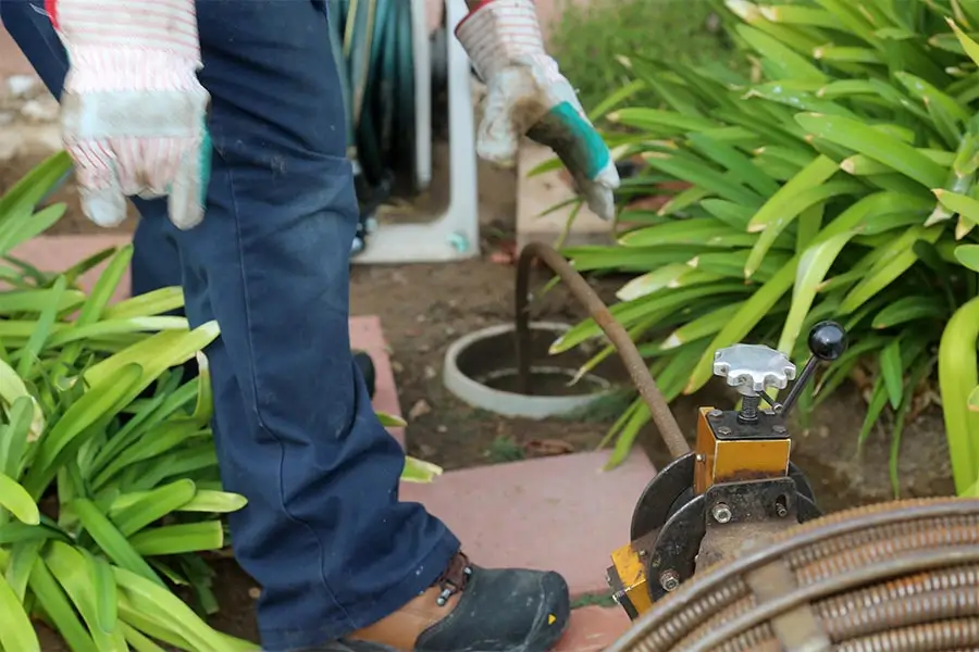 Plumber performing drain cleaning service