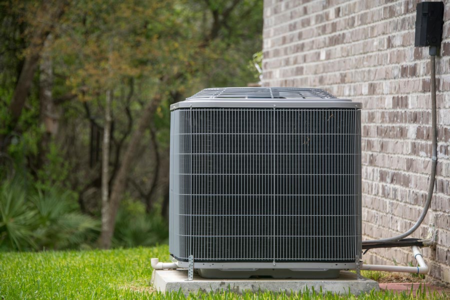 Outdoor AC unit by wall