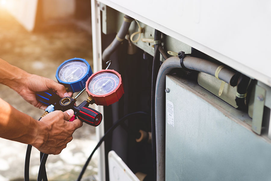 Technician checking AC pressure